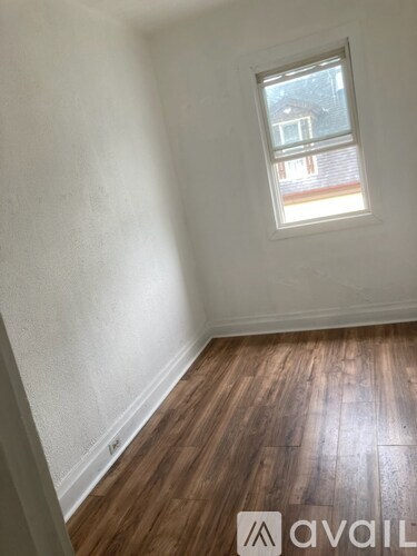 A room with wooden floors and a window.