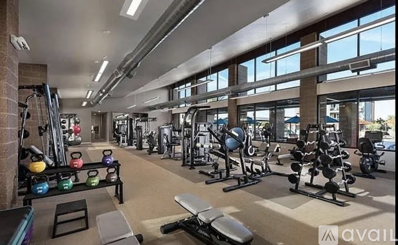 A gym with a variety of equipment including weights and machines.