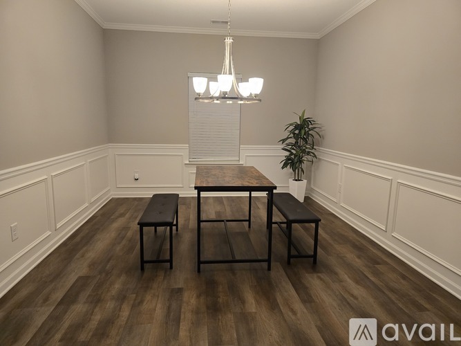 A dining room with a wooden table and benches.