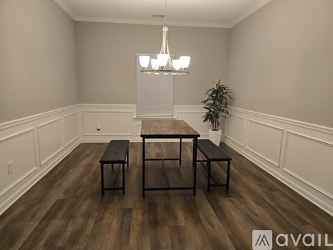 A dining room with a wooden table and benches.