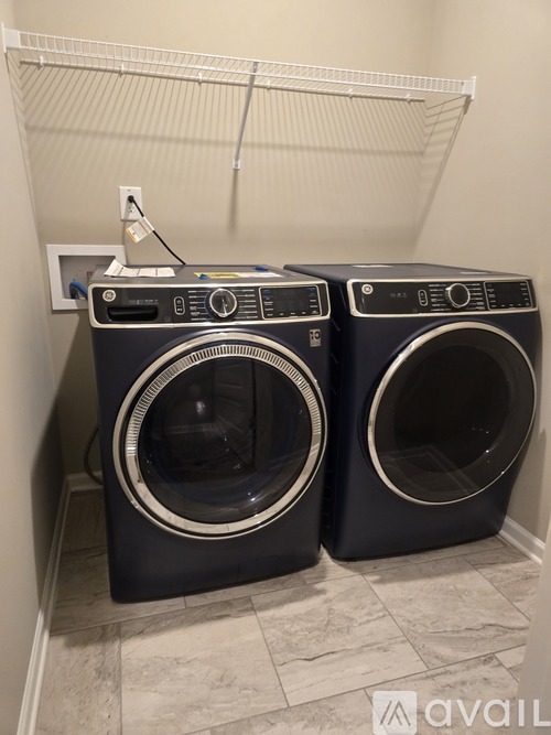 Two front load washing machines in a laundry room.