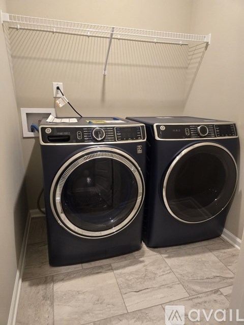 Two front load washing machines in a laundry room.