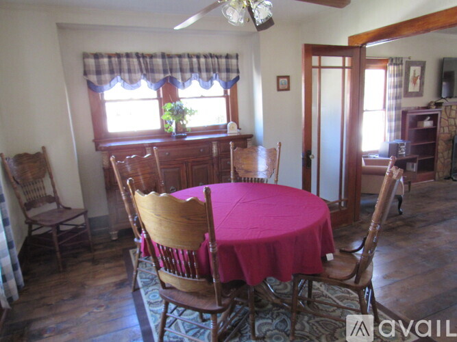 A dining room with a table set for four.