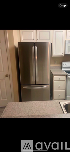 A stainless steel refrigerator in a kitchen.