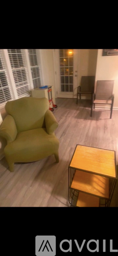 A yellow chair is in a room with a wooden table.