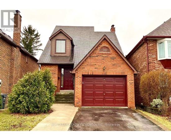 A red brick house with a garage door in the front.