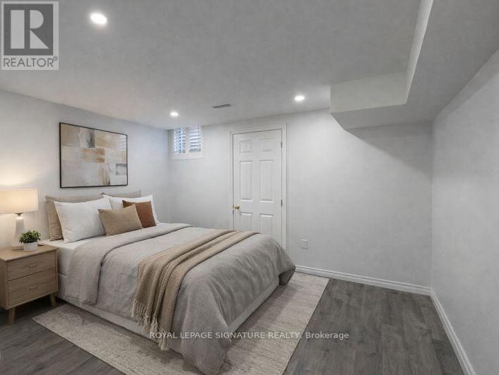 A bedroom with a large bed and a wooden nightstand.