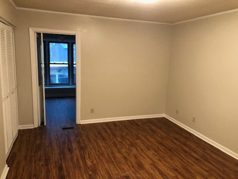 A room with wooden floors and a window.