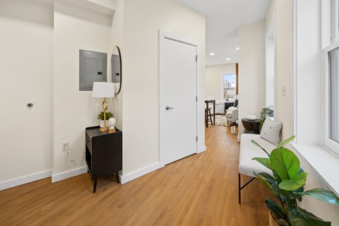 A living room with a white sofa and a wooden floor.