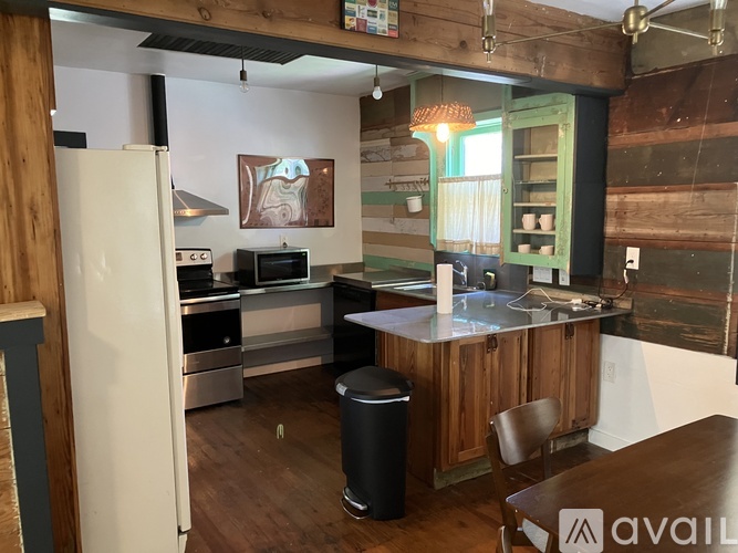 A kitchen with wooden cabinets and a white refrigerator.