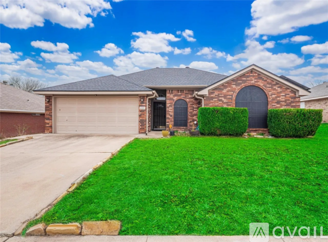 A house with a garage and a driveway in front.