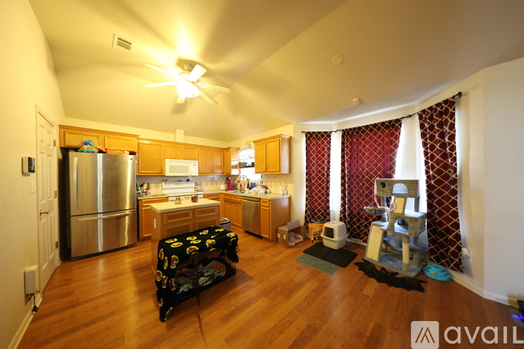 A kitchen with a refrigerator, microwave, and oven.