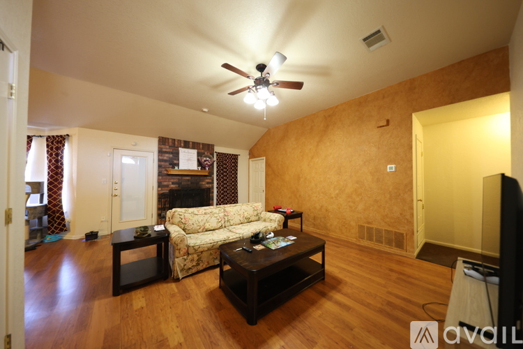 A living room with a couch, coffee table, and television.