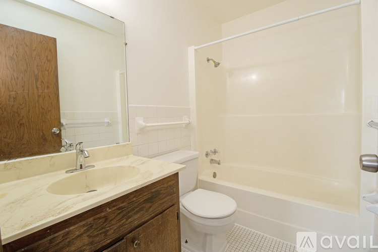 A bathroom with a sink, toilet, and bathtub.