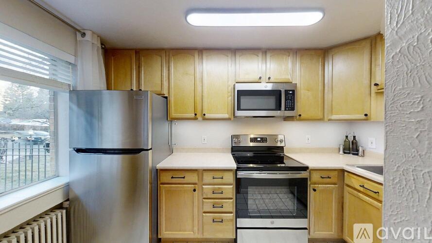 A kitchen with wooden cabinets and stainless steel appliances.