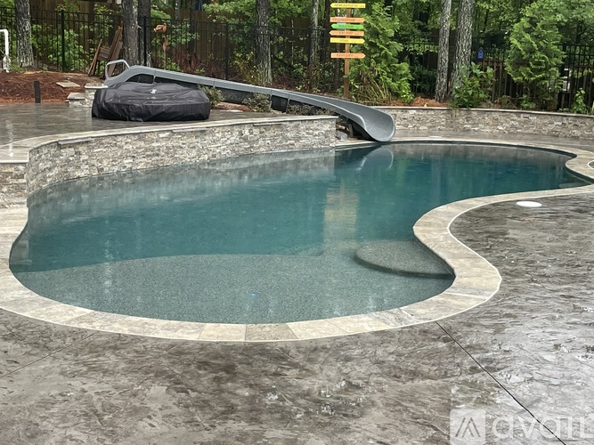 A small, round, in-ground pool with a stone border.