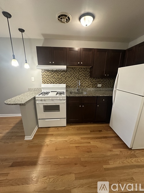 A kitchen with a white fridge and a white stove top oven.