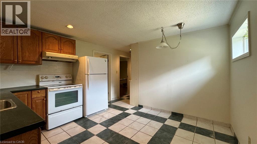 A kitchen with black and white checkered floor.