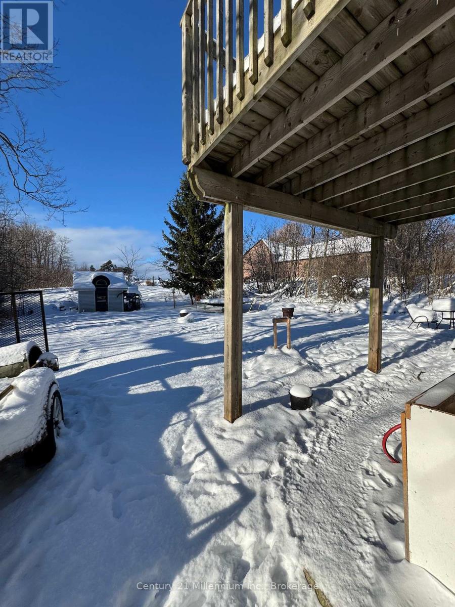 A snow-covered landscape with a wooden structure in the foreground.