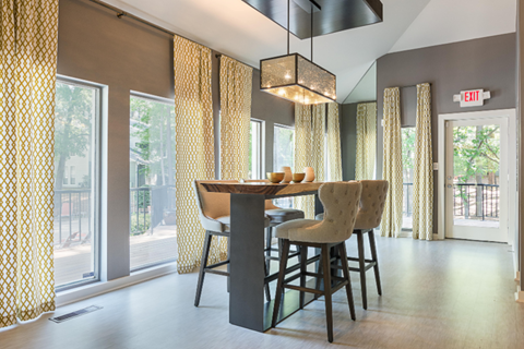 A dining room with a table and chairs.