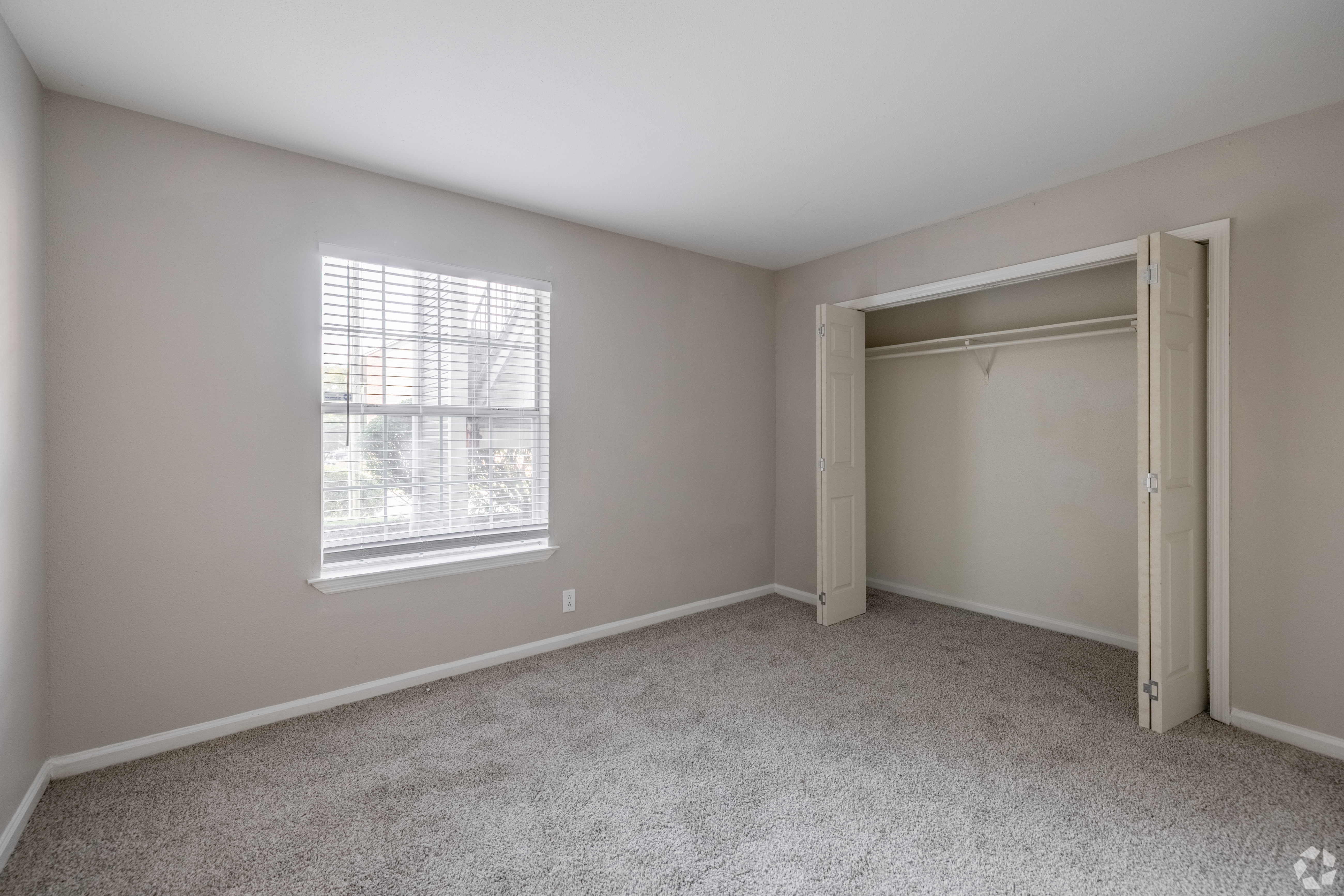 A room with a window and a door.