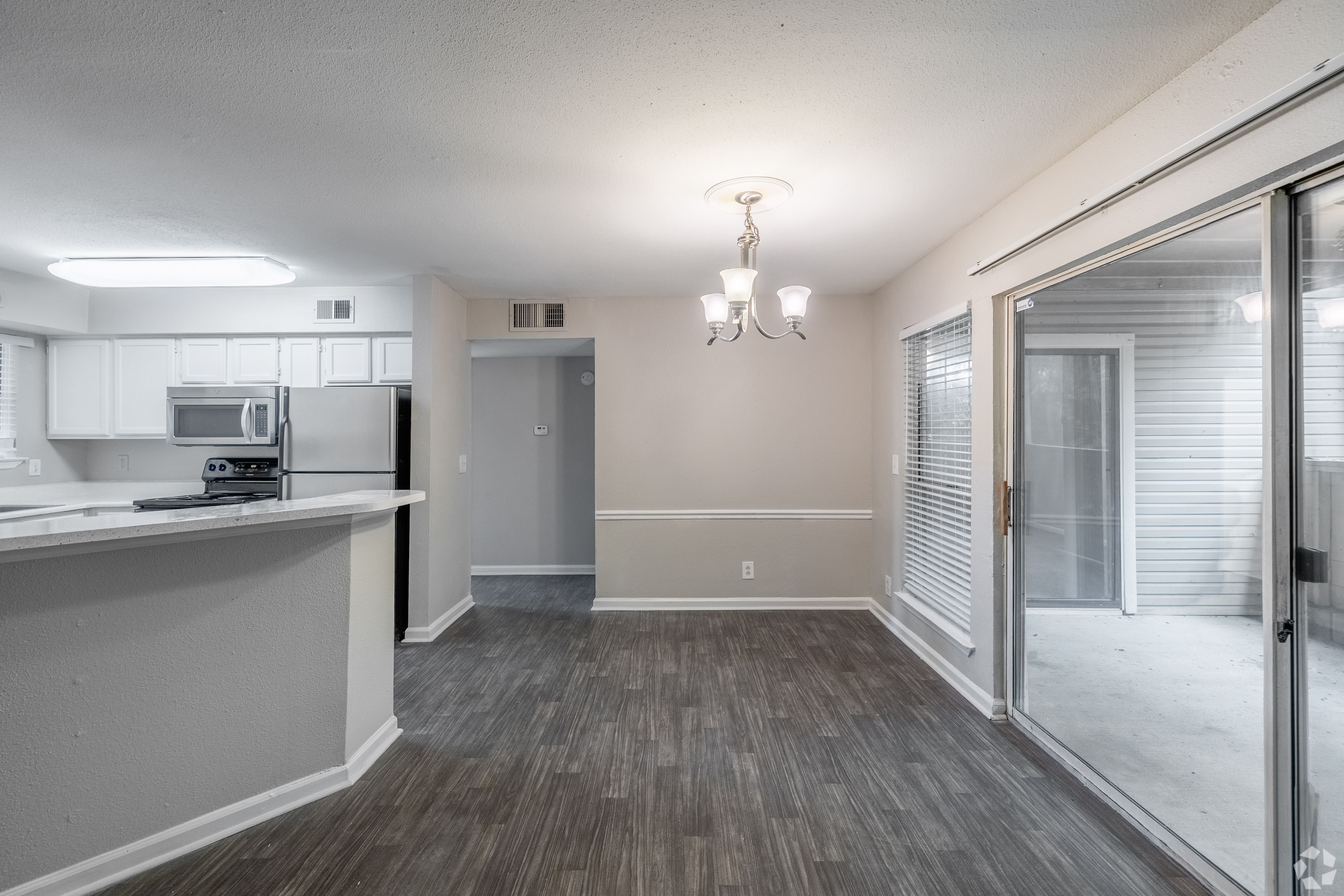 A kitchen with a microwave and refrigerator on the counter.