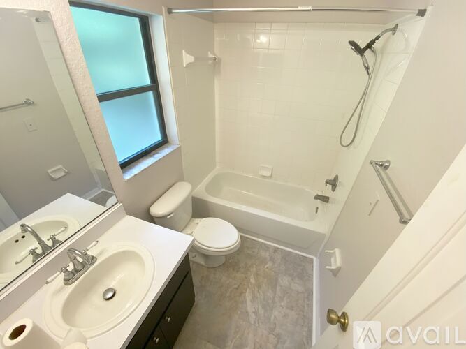 A bathroom with a toilet, sink, and bathtub.