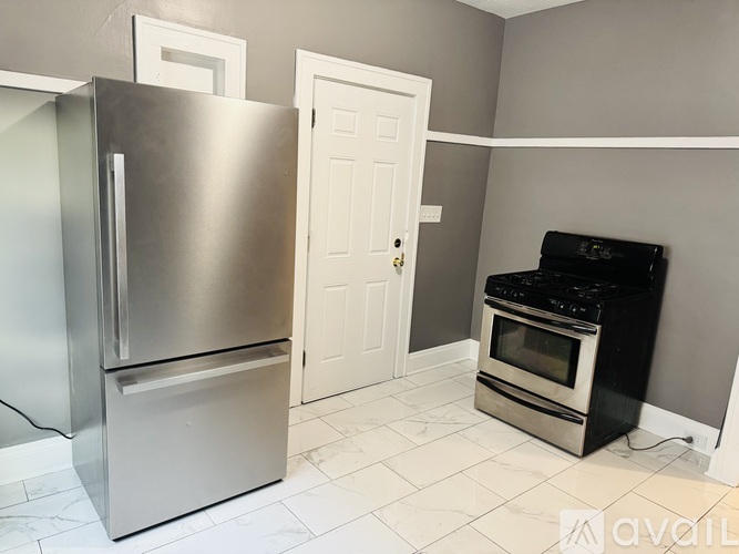 A kitchen with a stainless steel refrigerator and an oven.