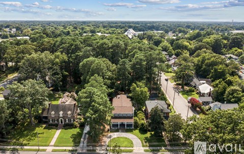 A bird's eye view of a residential area with houses and trees.