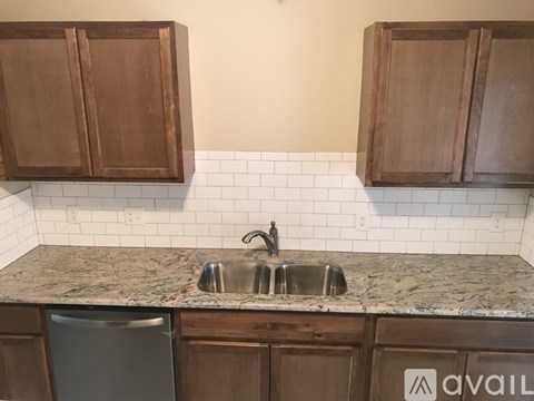 A kitchen with a sink and cabinets.