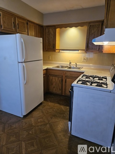 A kitchen with a white fridge and a blue stove.