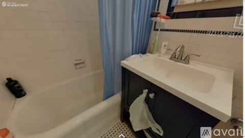 A bathroom with a white tub and sink.