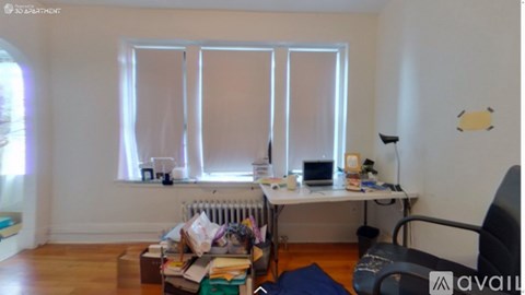 A room with a desk and a chair in it.