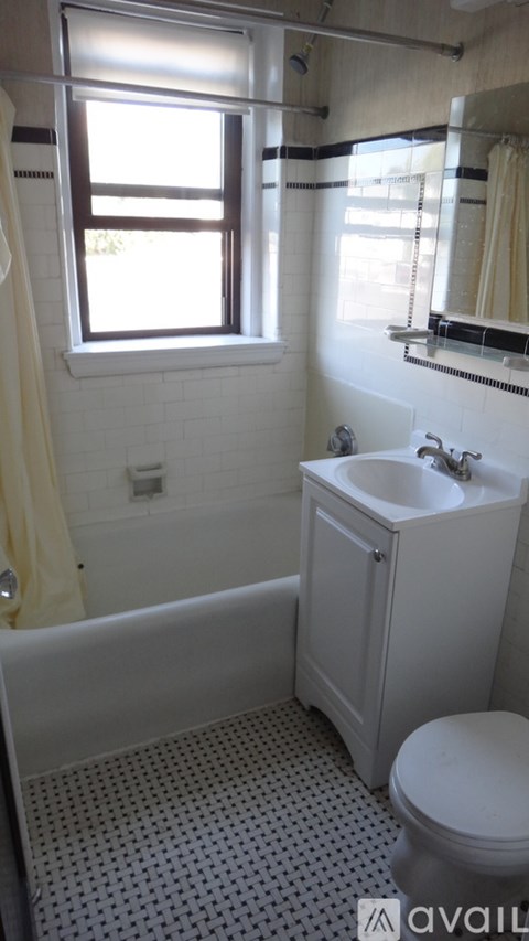A white bathroom with a toilet, sink, and tub.