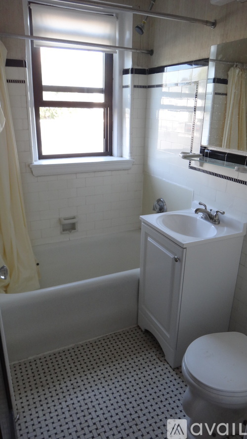 A white bathroom with a toilet, sink, and tub.