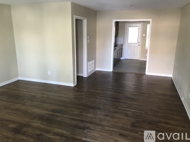 A room with wooden floors and white walls.
