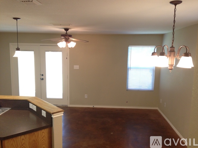 A kitchen with a fan and a window.
