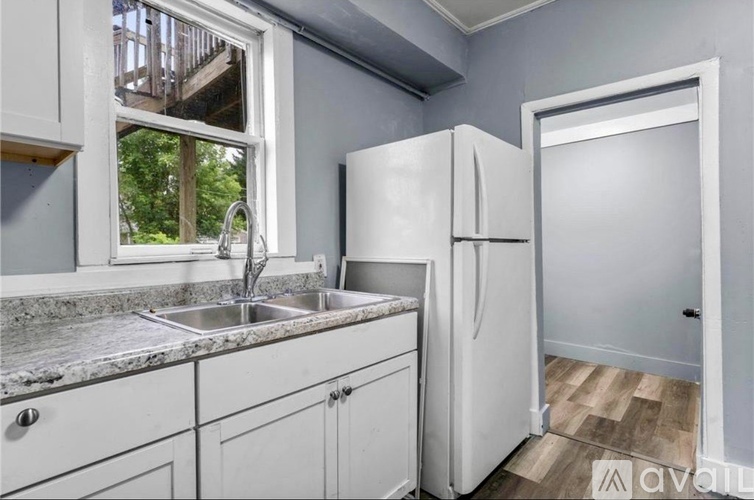 A kitchen with a white fridge and cabinets.