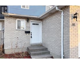 A house with a white door and a sign that says REALTOR.