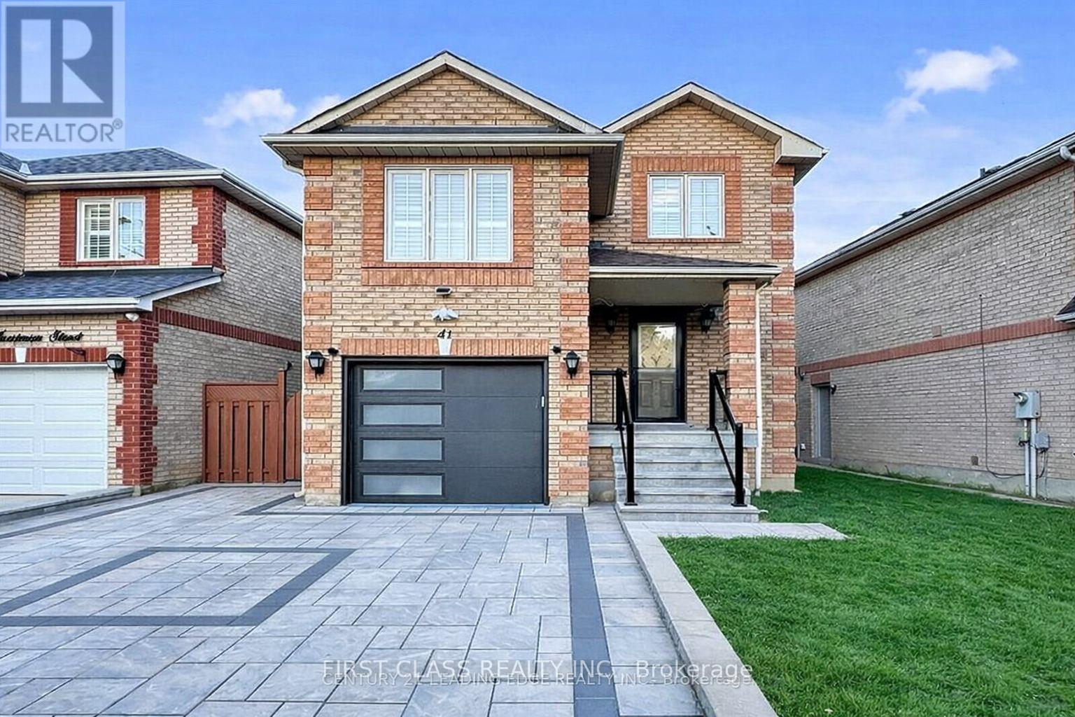 A brick house with a garage door is for sale.