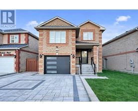 A brick house with a garage door is for sale.