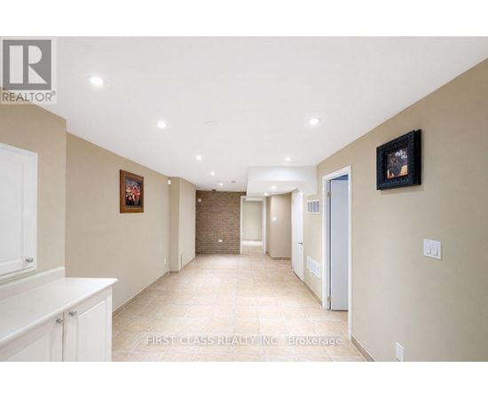 A hallway with a white cabinet on the left and a framed picture on the wall.