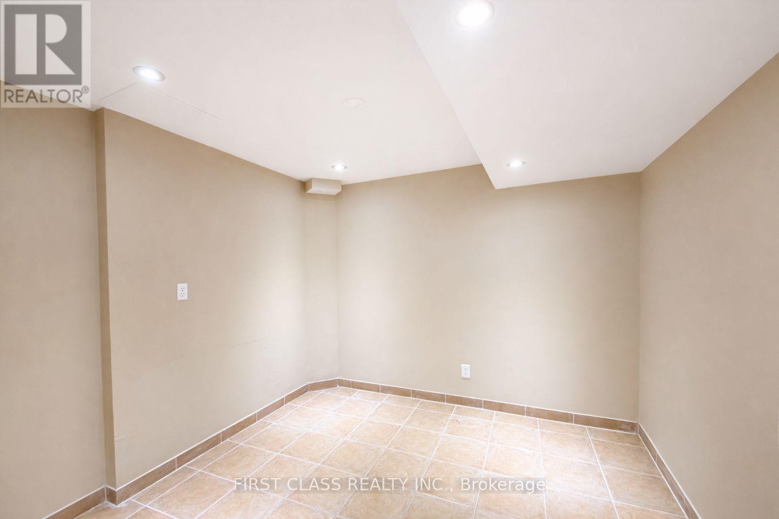A room with beige walls and a tiled floor.
