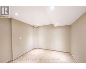 A room with beige walls and a tiled floor.