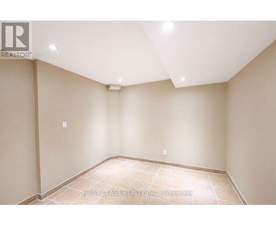 A room with beige walls and a tiled floor.