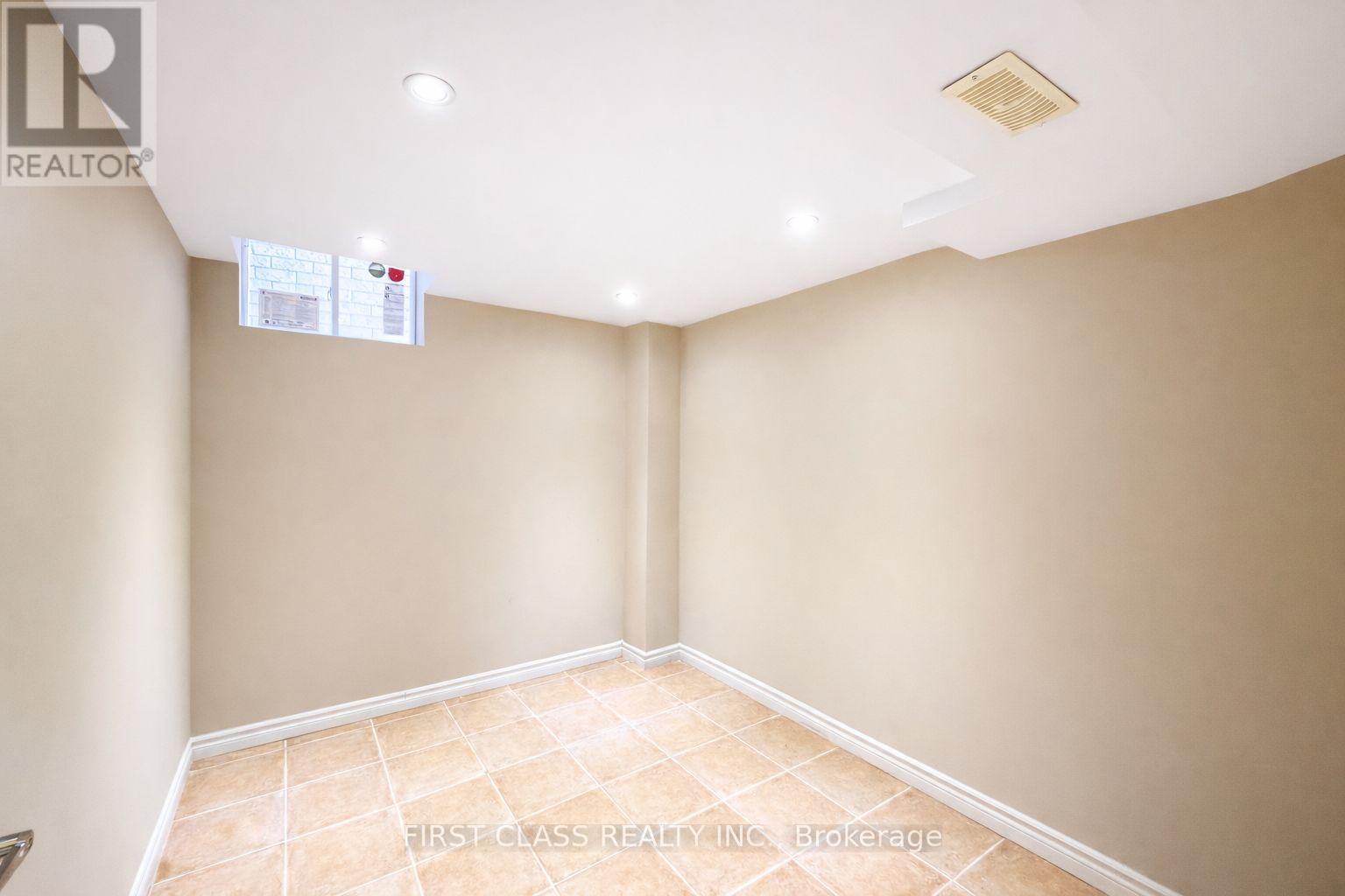 A room with a tiled floor and a ceiling with a light fixture.