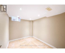 A room with a tiled floor and a ceiling with a light fixture.