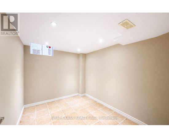A room with a tiled floor and a ceiling with a light fixture.