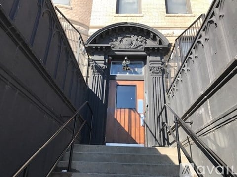 Steps leading to a door with a window above it.