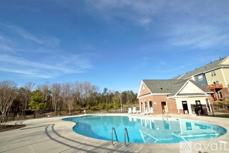 A large swimming pool in front of a house.